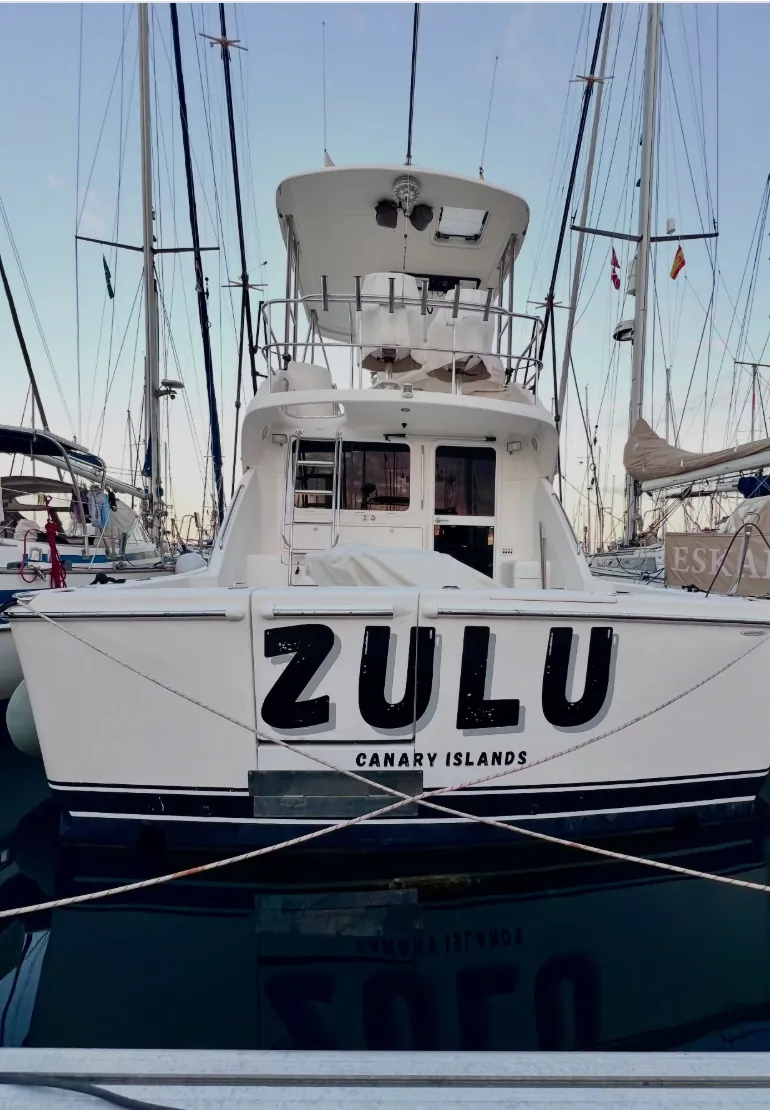 Stern of the ZULU charter boat moored in the marina