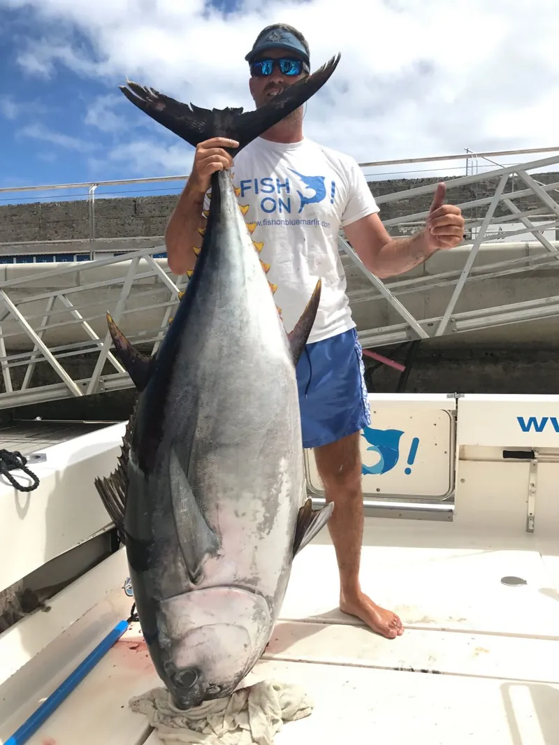Angler with a big tuna caught on a full day trip