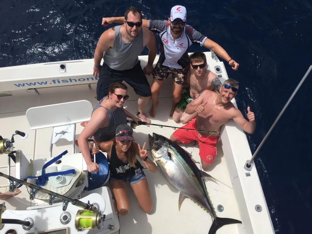 Group of friends celebrating a tuna on board